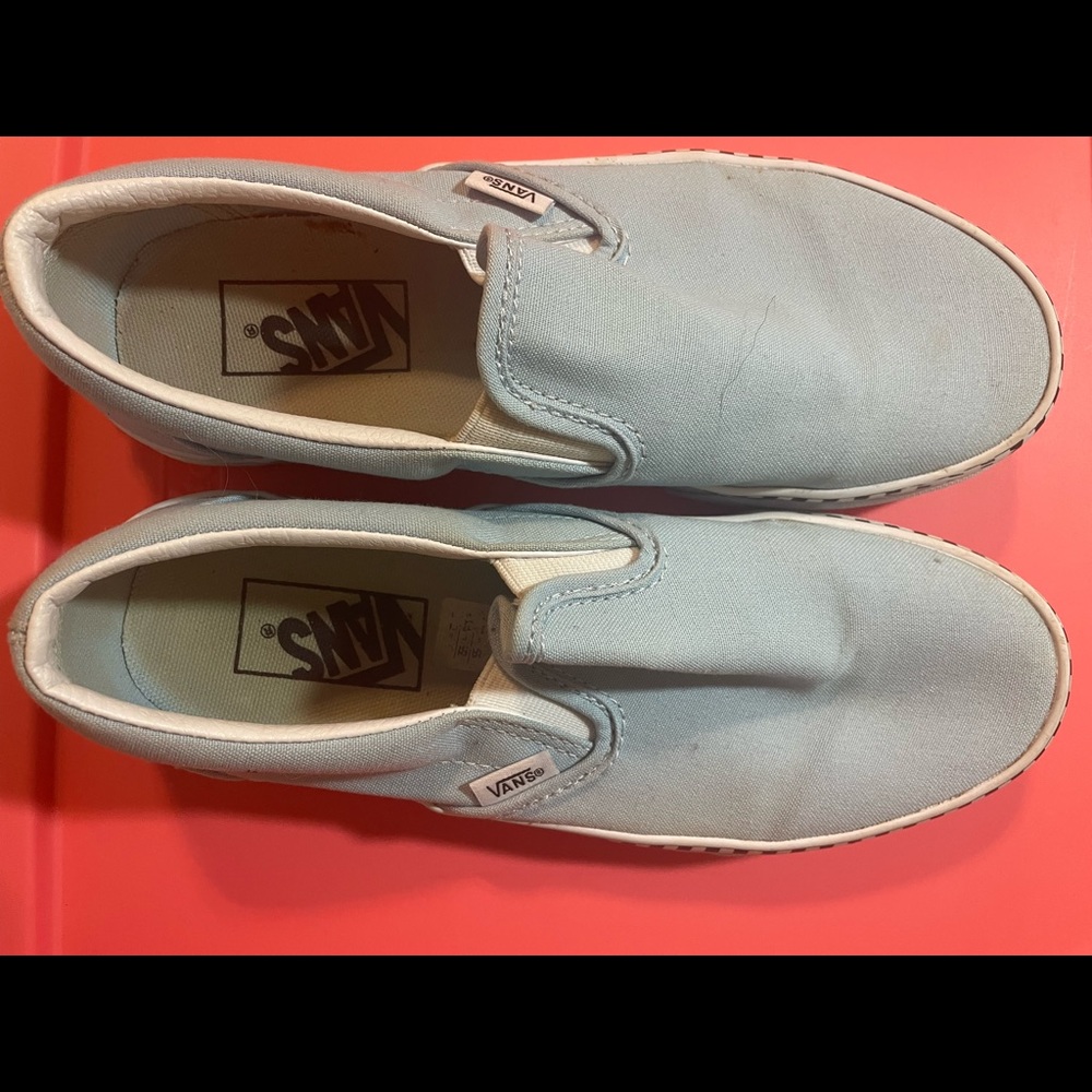 Baby blue vans with checkerboard trim.